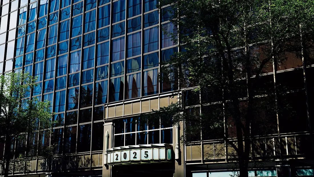 A glass-fronted office building on a city street