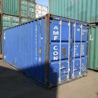 Stacked twenty-foot shipping containers in a yard