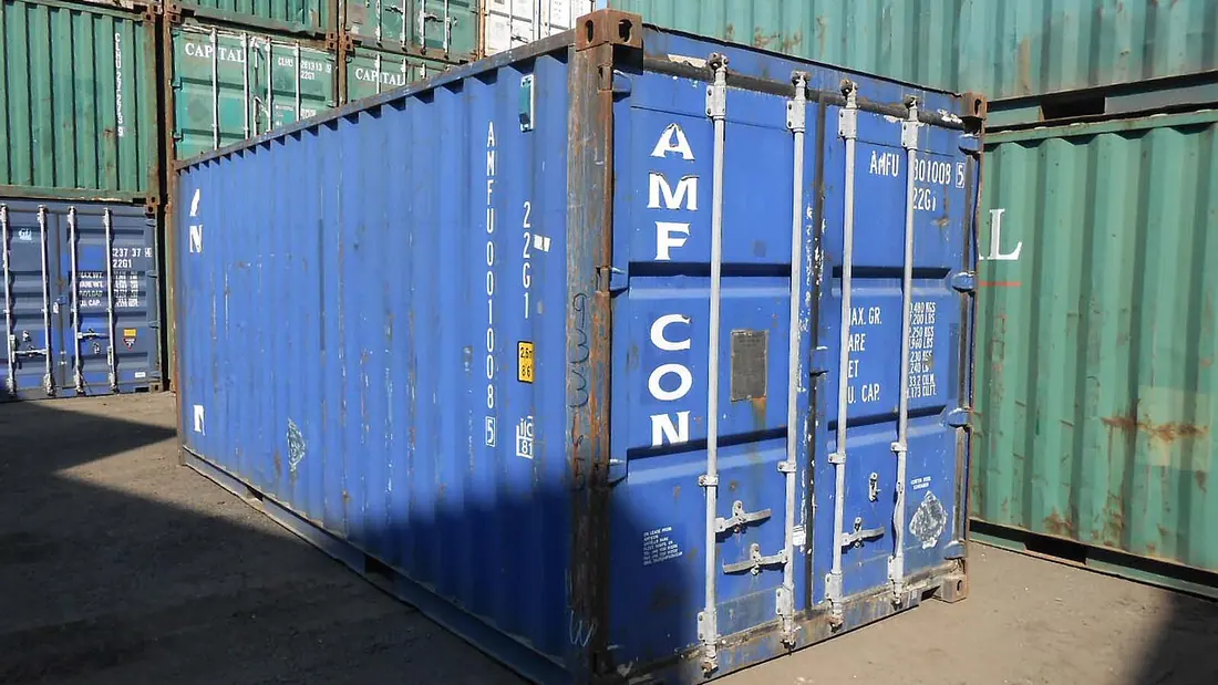 Stacked twenty-foot shipping containers in a yard