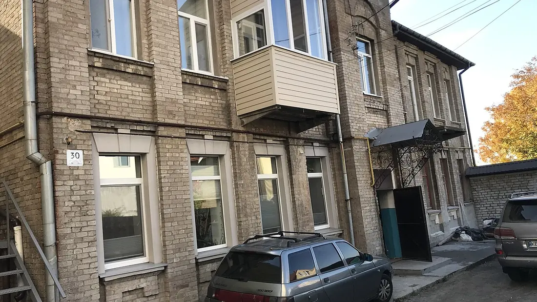 A multi-storey apartment block seen from the street