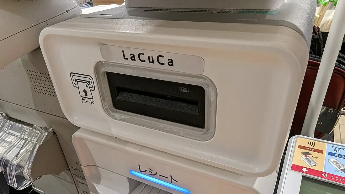 A card reader on a supermarket checkout counter