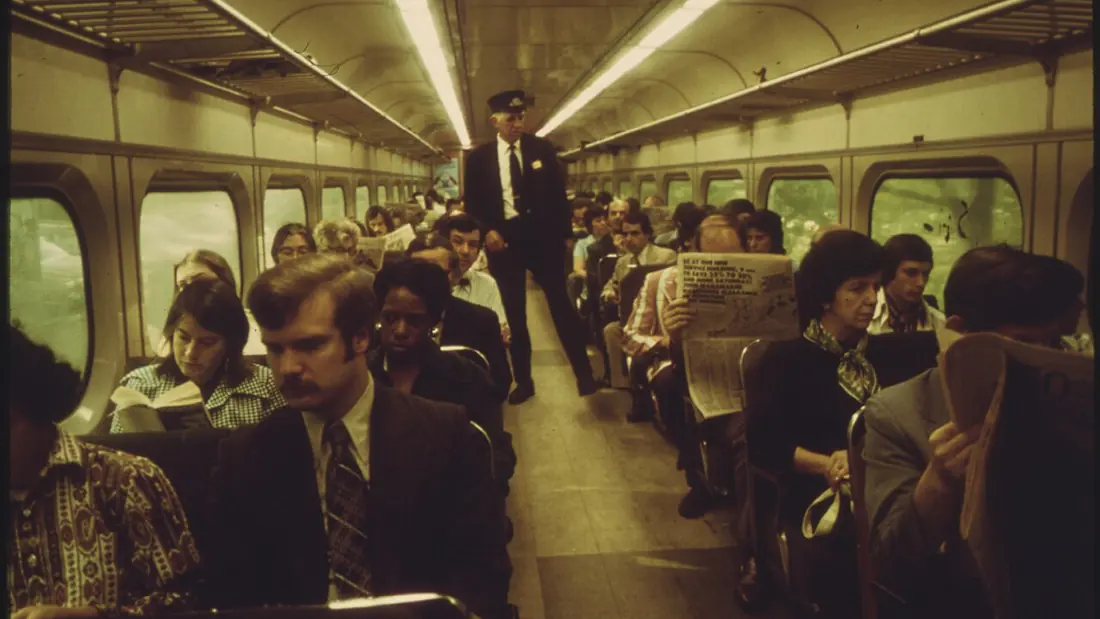 Passengers standing shoulder to shoulder in a crowded commuter car