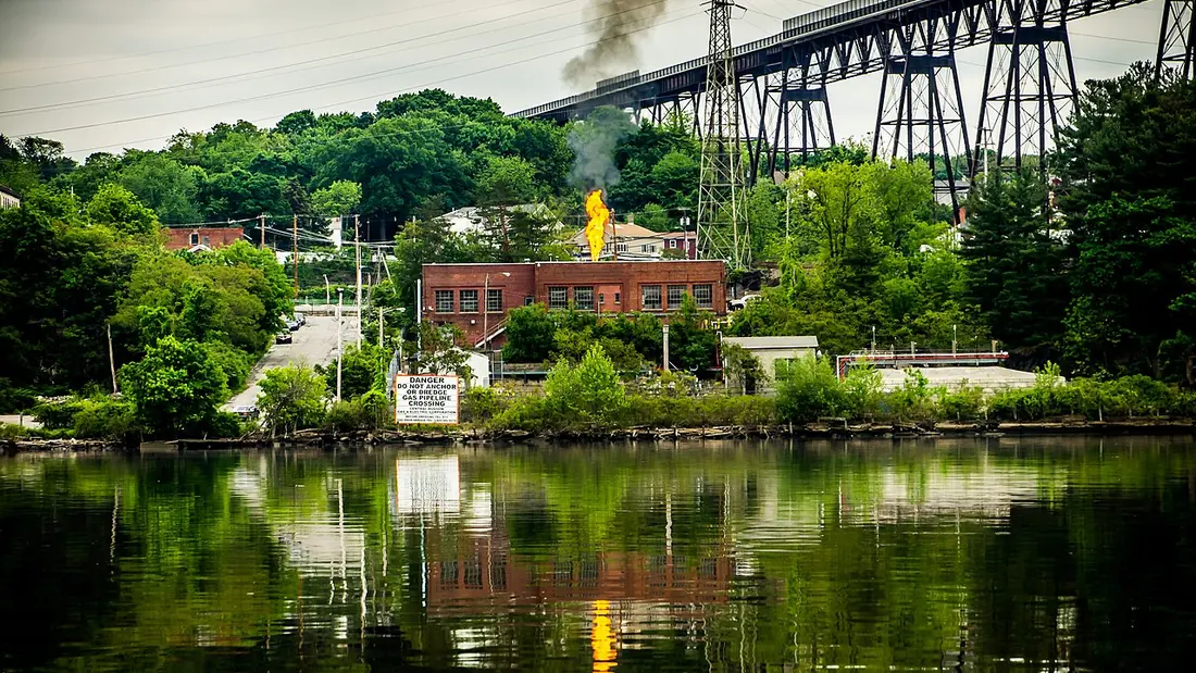 A natural gas vent pipe standing among trees