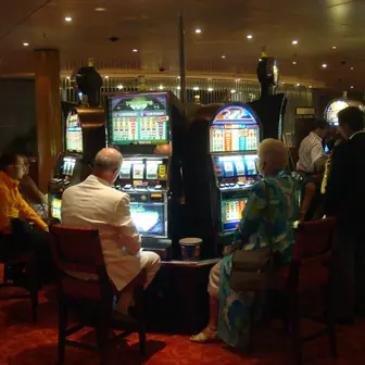 A row of gambling machines in a lit interior