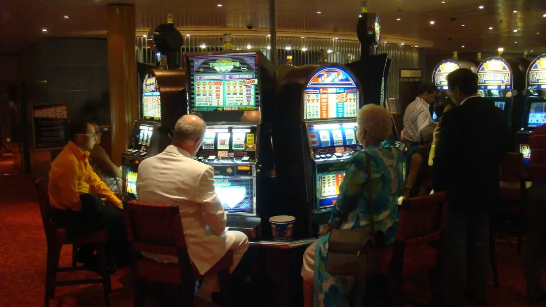 A row of gambling machines in a lit interior