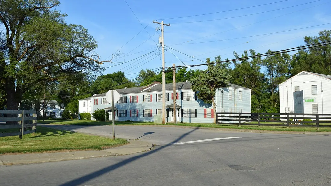 Low brick apartment buildings along a residential street