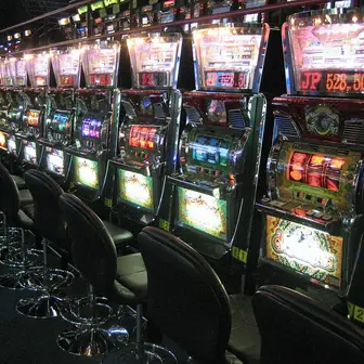 A slot machine cabinet with reels and buttons