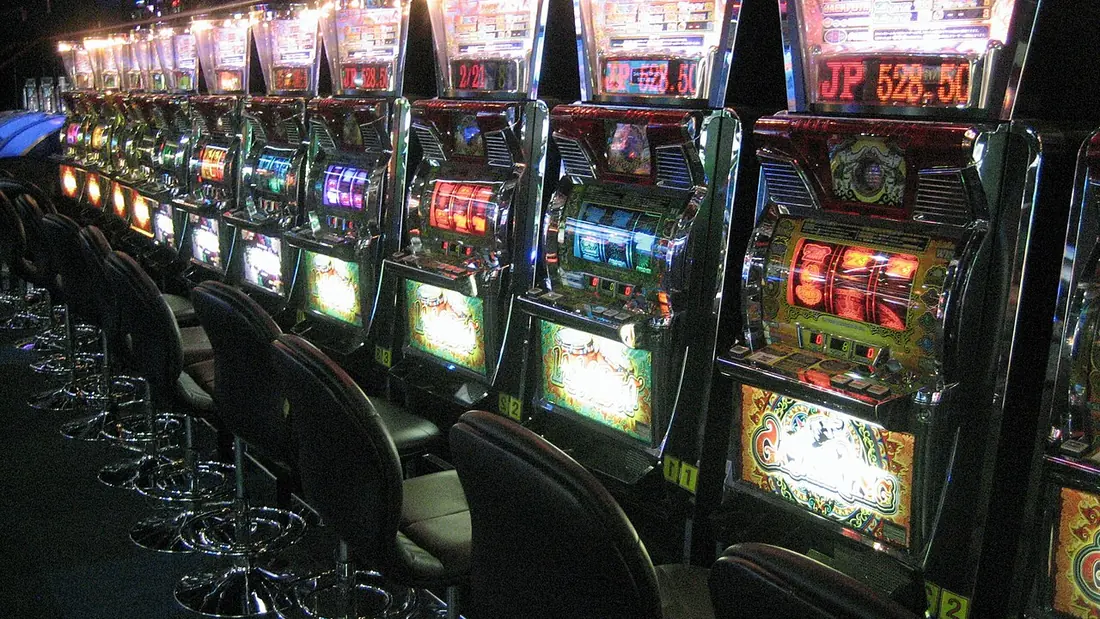 A slot machine cabinet with reels and buttons